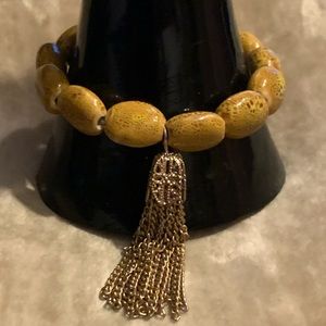 Ceramic Coated Bead Stretch Bracelet with Designer Gold Tassel